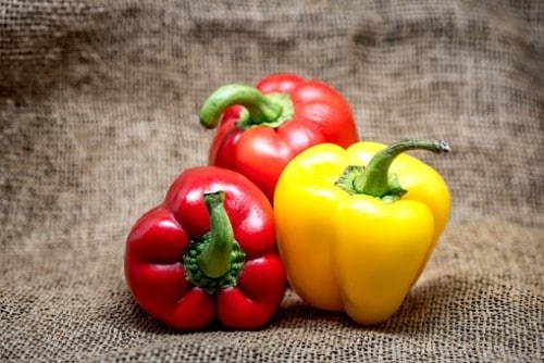 Three red and yellow bell peppers