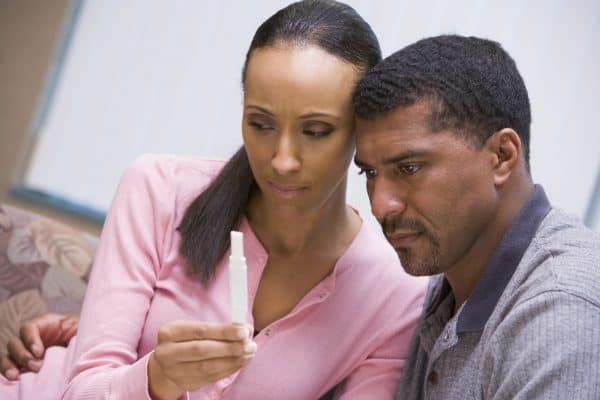 Couple looking at negative home pregnancy test