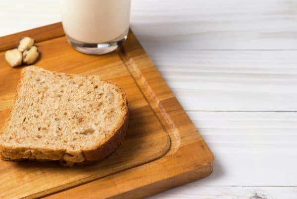 Bread and milk on a wooden cutting board