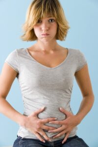 A woman with her stomach in pain
