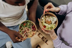 People-holding-healthy-food-bowls