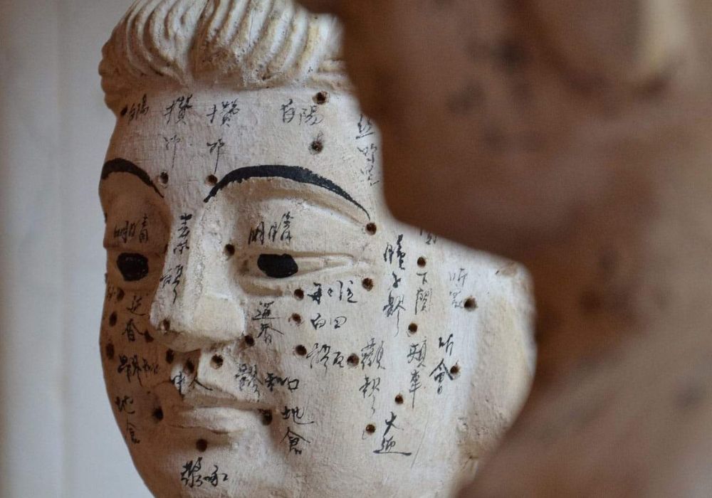 A buddha statue with writing on it