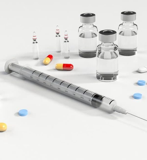 A syringe, pills and other medical supplies